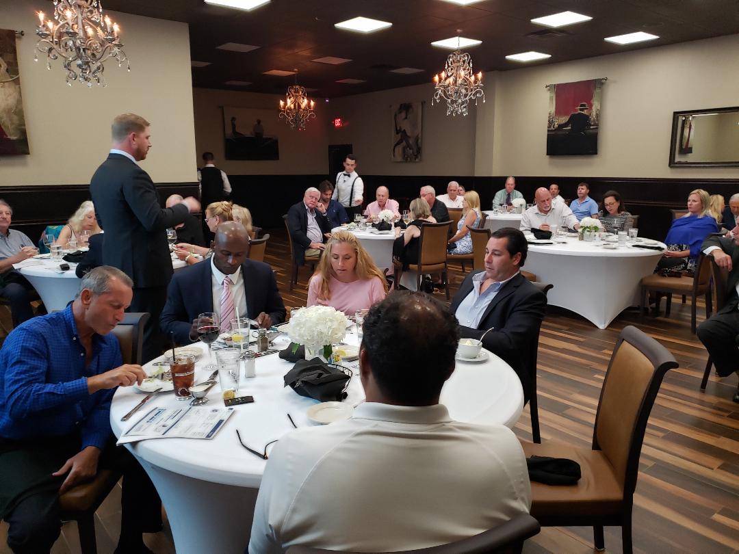 Investors dining at round tables before the formal presentation begins