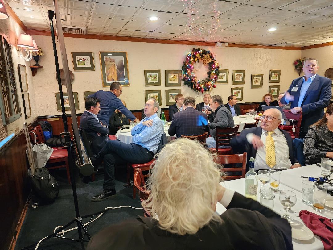 Guests at round tables during a holiday-season investor presentation
