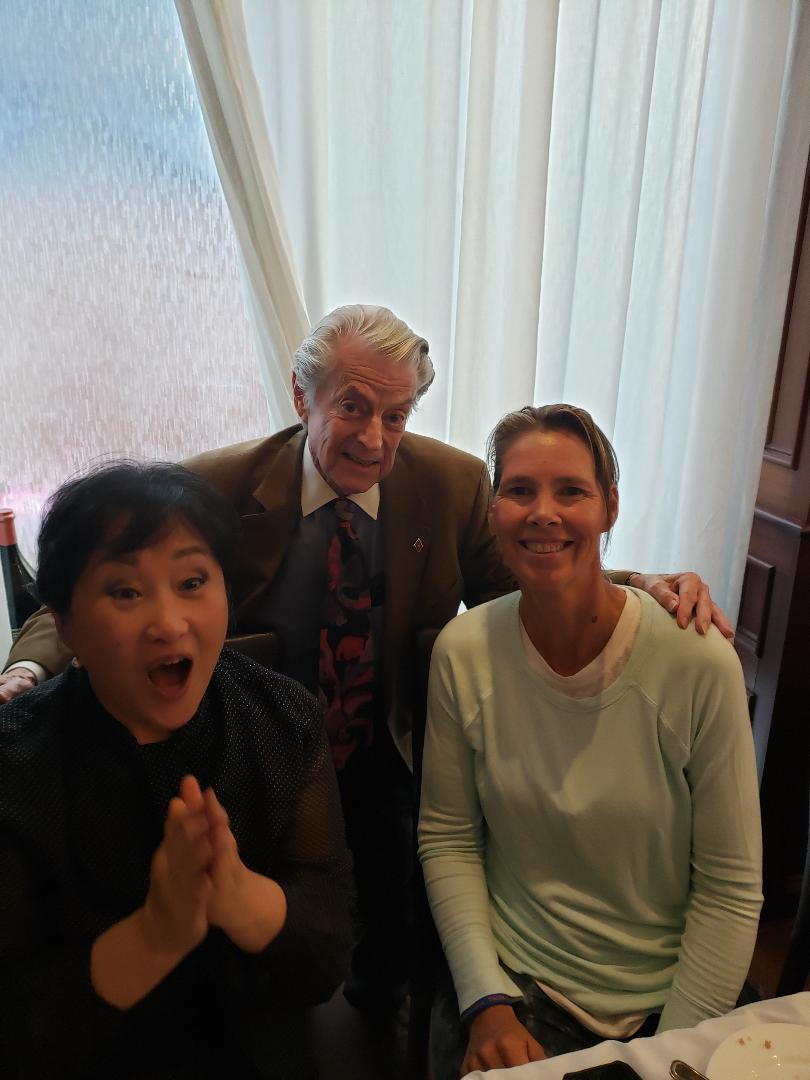 Guests and a former professional tennis player seated together at a meeting