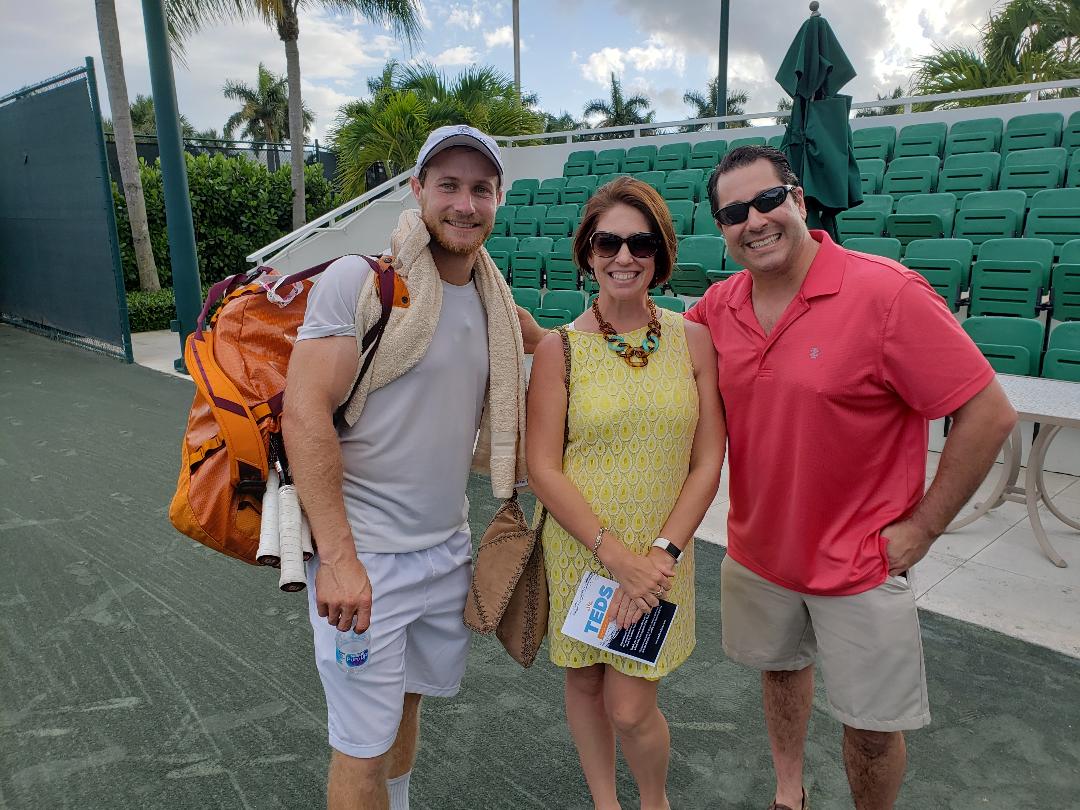 Investors standing courtside with Roger Federer's coach at a VIP event