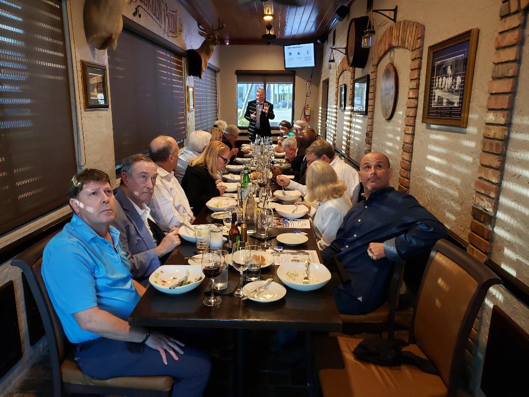 Attendees turning toward the camera during a private dinner presentation