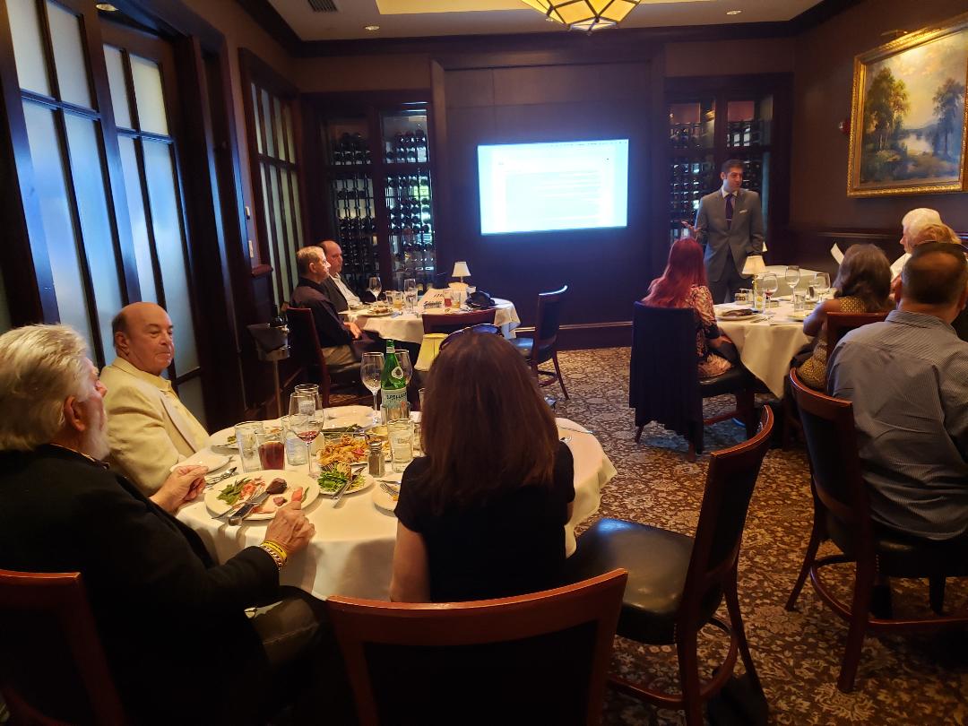 An investor presentation underway in a steakhouse wine room