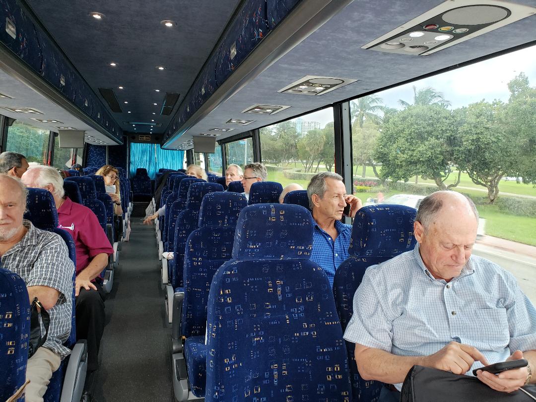 Investors aboard a chartered coach traveling to a site visit